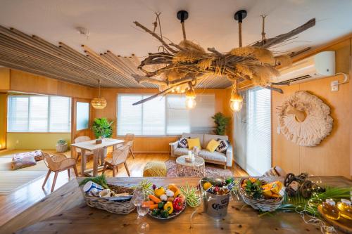 a living room with a table with fruits on it at SEA VIEW HOUSE KIRA KIRA HINANO in Nanjo