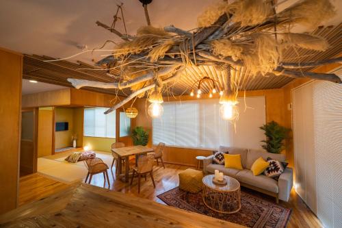 a living room with a couch and a table at SEA VIEW HOUSE KIRA KIRA HINANO in Nanjo
