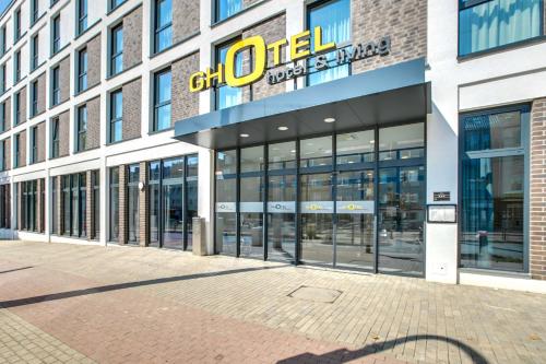 a building with a sign on the front of it at GHOTEL hotel & living Bochum in Bochum