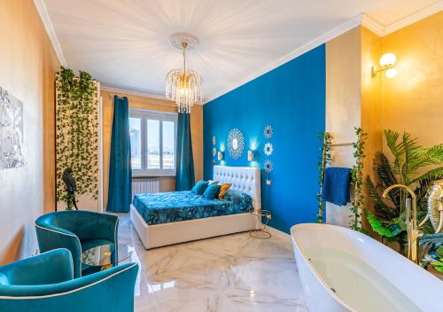 a blue bedroom with a tub and a bed at JUNGLE SUITE --- VASCA in camera in Turin