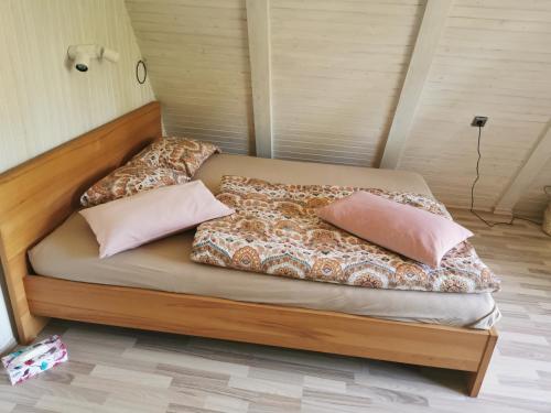 a bed with two pillows on it in a room at Holiday Home Magnolia in Trakošćan