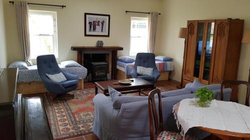 a living room with a couch and chairs and a table at Buchu & Num-num in Stanford