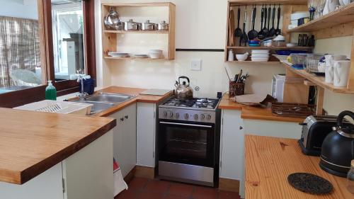 a kitchen with a stove and a sink at Buchu & Num-num in Stanford