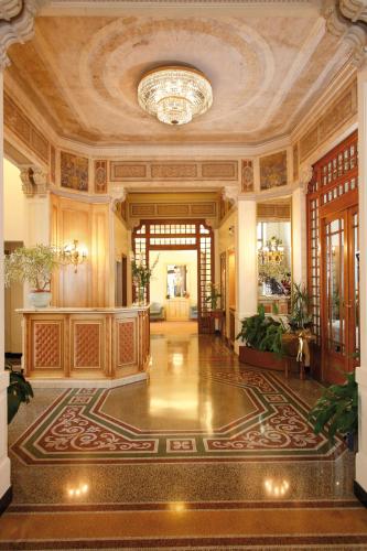 a large lobby with a ceiling with a chandelier at Hotel Villa Elena in Varazze