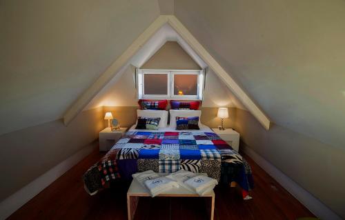 a attic bedroom with a bed in a attic at Cedofeita Village Porto in Porto