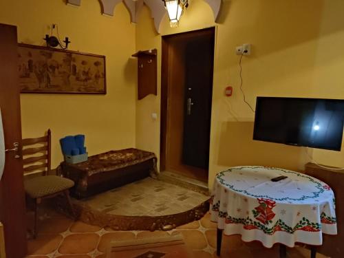 a living room with a table and a television at Готель-Маєток in Luts'k
