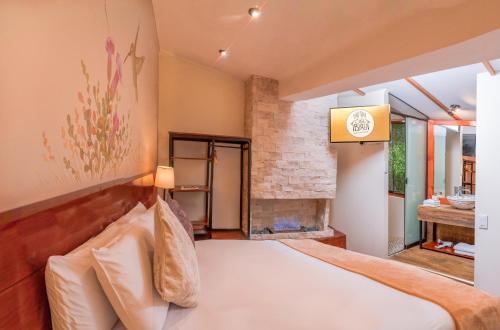 a bedroom with a bed and a fireplace at Casa Biru Hotel Boutique in Cusco