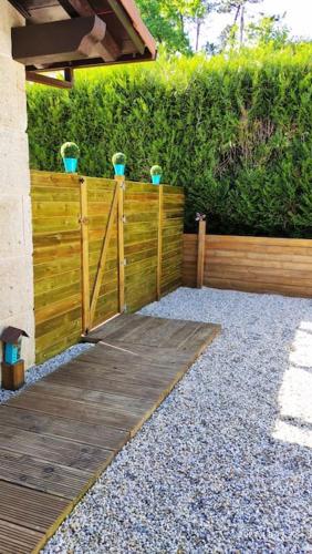 a wooden fence with potted plants on top of it at Casa nueva en Vigo Rural Mos con Jacuzzi y chimenea in Pontevedra