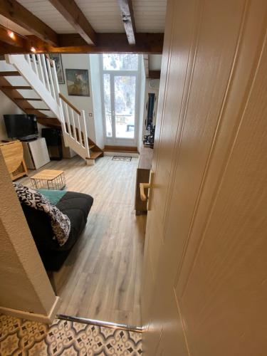 a hallway with a stairway leading to a living room at Helios 105 wifi et terrasse in Barèges