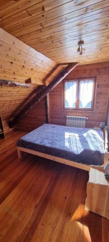 a bed in a wooden room in a cabin at Lou Francese in Ceillac