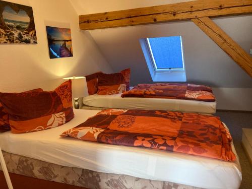 two beds in a room with a window at Landhausidyll Apartment Wohn- und Schlafzimmer in Klütz
