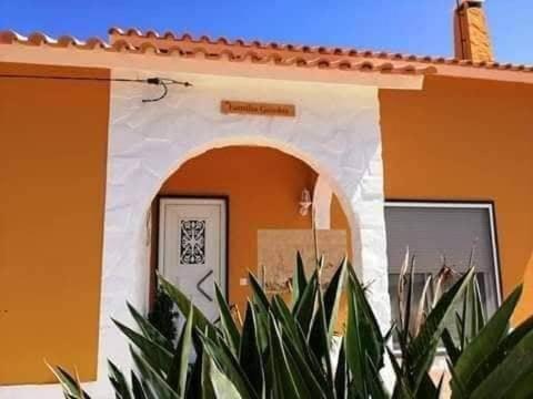 a building with an archway in front of a house at Família Gaiolas in Marinhais