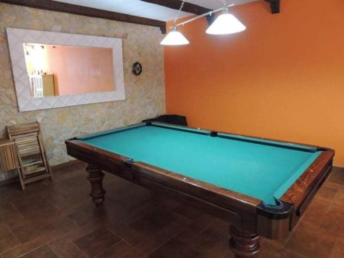 a pool table in the middle of a room at Família Gaiolas in Marinhais