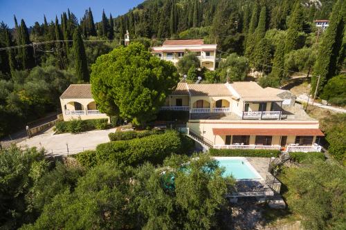 an aerial view of a house with a swimming pool at Dimitra Studios in Benitses