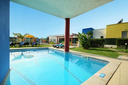 a large blue swimming pool in a building at Marina Sol by Atlantic Places in Albufeira