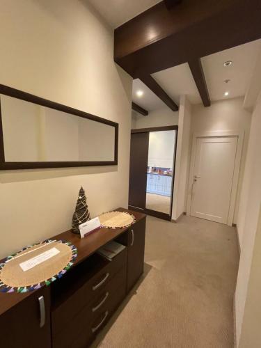 a bathroom with a sink and a large mirror at Apartman Zlatibor Square in Zlatibor