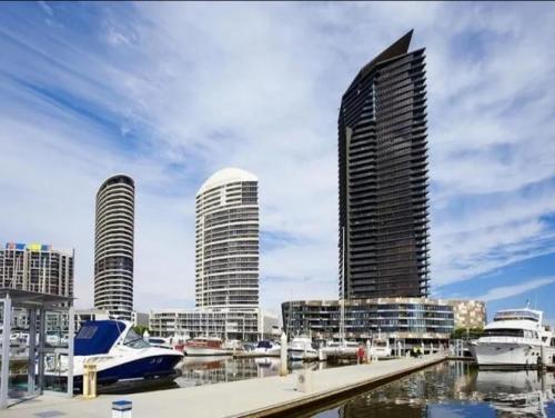 a view of a city with tall buildings and boats at Lovely waterfront condo with swimming pool and gym in the heart of Docklands in Melbourne
