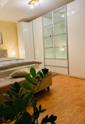 a bedroom with a bed and a plant at Casa Central Luxury in Oradea