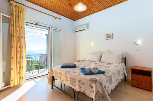 a bedroom with a bed and a balcony at Villa Katina in Nisakion