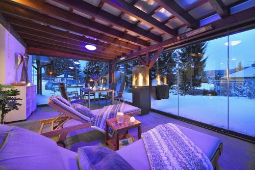 a living room with purple furniture and a large window at Rekreační domek Kobylnice Lipno in Lipno nad Vltavou