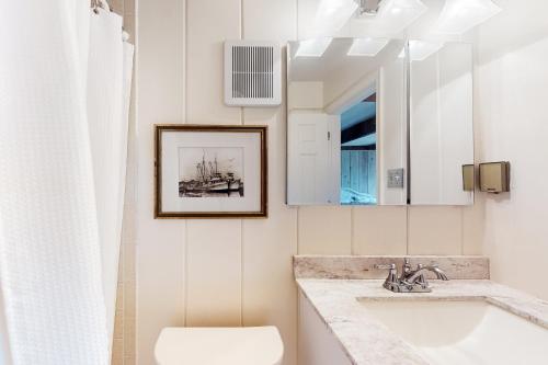 a bathroom with a sink and a mirror at White Sands Village 27 in Ocean City