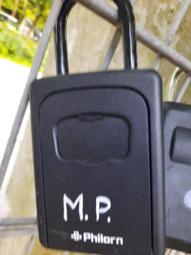 a black suitcase with the words m and p on it at Appartement am Ossiachersee in Villach