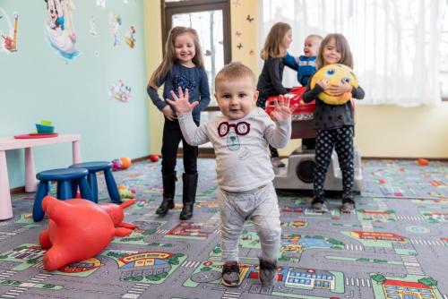 a group of children standing in a room with a baby at SPA Hotel Medicus in Varshets