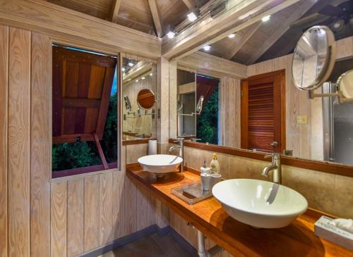 a bathroom with a sink and a mirror at Casa Chiesa in English Harbour Town
