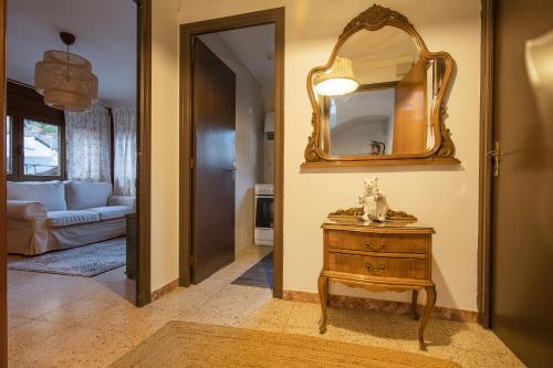 a hallway with a mirror and a wooden table at JAT Mountain Houses - Casa Agustí 3er pis - Cèntric, al costat del Telecabina de Canillo in Canillo