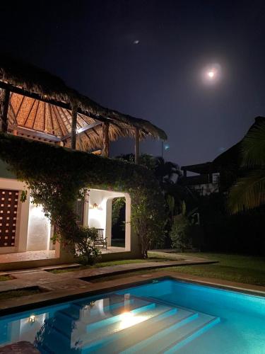 a house with a swimming pool at night at Casa Maya private villa on the beach in Puerto Escondido