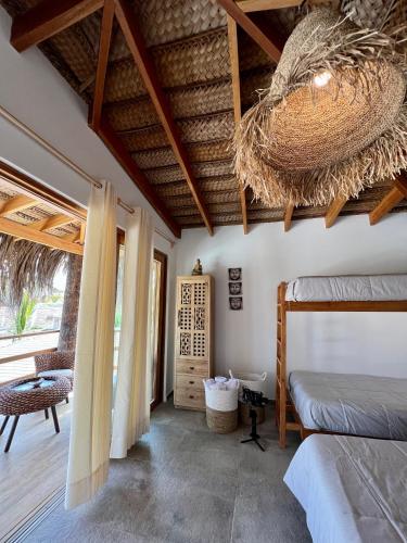a bedroom with two bunk beds and a ceiling at Casa Bali Vichayito in Vichayito
