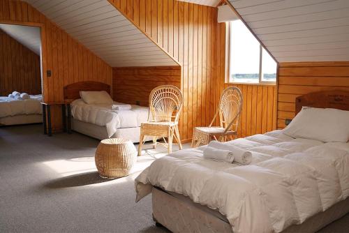 Un pat sau paturi într-o cameră la Hotel Posada del Río - Chile Chico