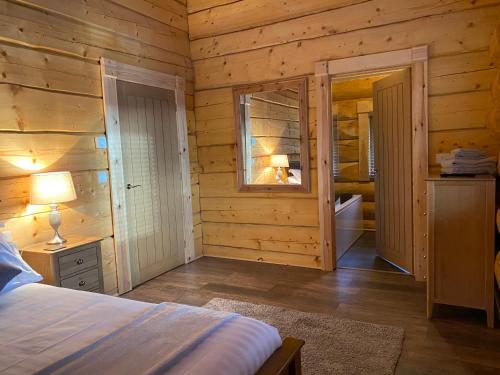 Кровать или кровати в номере Ewes Water Log Cabins