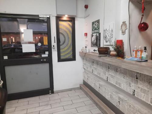 a restaurant with a counter and a glass door at Superior Motel in Haifa