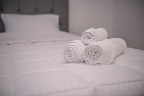 a pile of rolled towels on a bed at Hotel Santa Lucia in Socorro