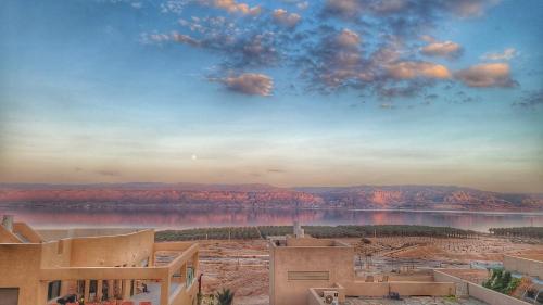 a view of a desert with a lake and mountains at Dead Sea Rooftop - גג ים המלח in Ovnat