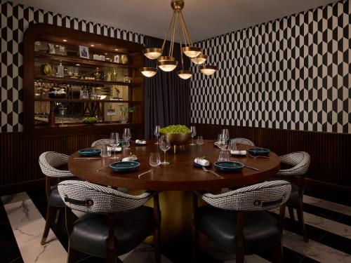 a dining room with a wooden table and chairs at PGA National Resort in Palm Beach Gardens