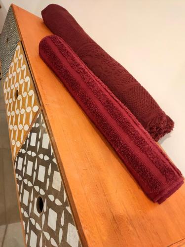 two red cushions sitting on a wooden cutting board at Interno 7 in Barletta
