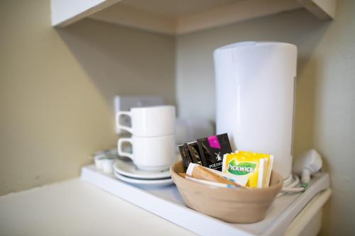 a counter with a bowl of food and a coffee maker at Central Hotel in London
