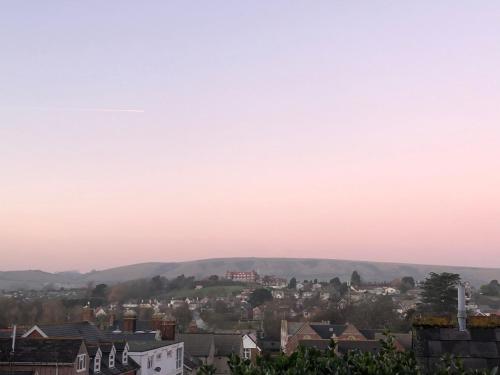 a view of a town with mountains in the background at Purbeck Hill View in Swanage