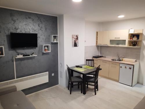 a kitchen and dining room with a table and chairs at Studio Sanja in Soko Banja