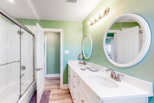 a bathroom with a sink and a mirror at Life's a Beach in Dauphin Island