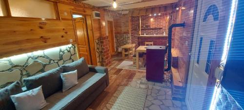 a living room with a couch and a table at Durmitorske zore in Žabljak