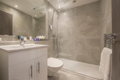 a bathroom with a toilet sink and a shower at Crowne Plaza - Sheffield by IHG in Sheffield