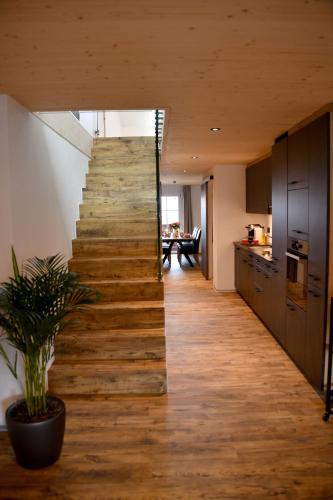a staircase in a kitchen with a wooden floor at Hôtel de Ville in Gruyères