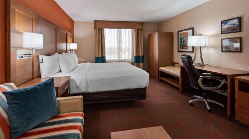 a hotel room with a bed and a desk at Best Western Cannon A.F.B. in Clovis