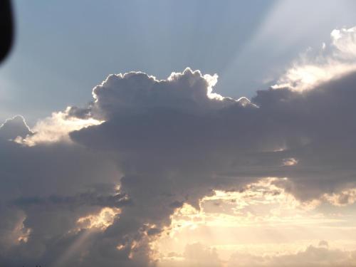 a cloudy sky with the sun peeking through the clouds at A Casa Di Mì Appartamenti vacanza in Montefalco