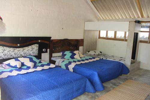 Cama o camas de una habitación en Yaharo Posada Turística