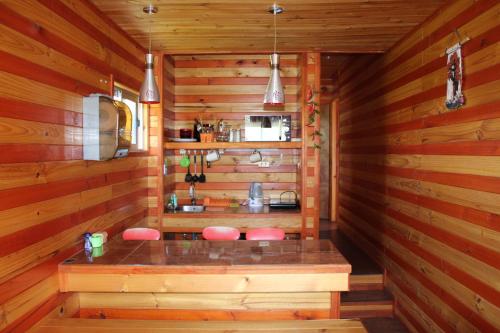 una sauna con taburetes rosas en una cabaña de madera en Algarrobo Lodge, en Algarrobo