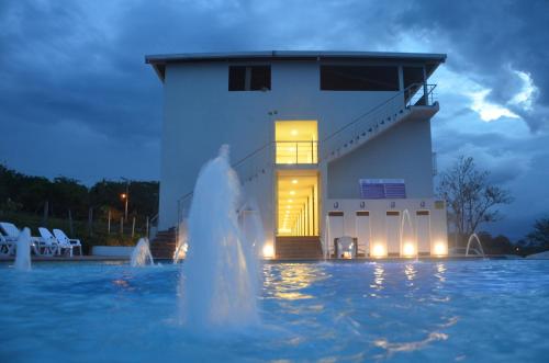 a water fountain in front of a building at night at Hotel Santa Lucia in Socorro